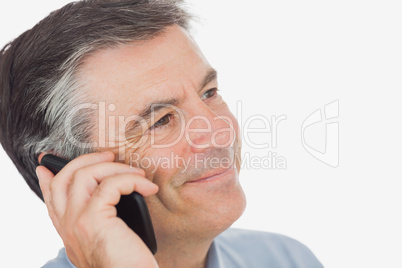 Businessman smiling while using mobile phone