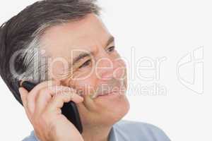 Businessman smiling while using mobile phone