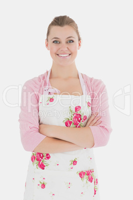 Young woman in apron with arms crossed