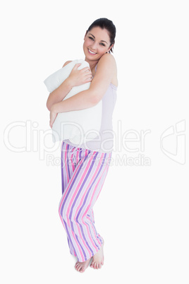 Smiling woman holding a pillow