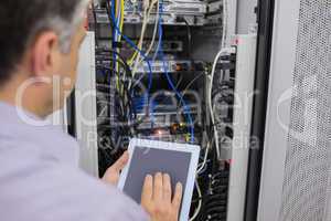 Man doing  server maintenance with tablet pc