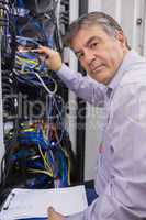 Technician adjusting server wires