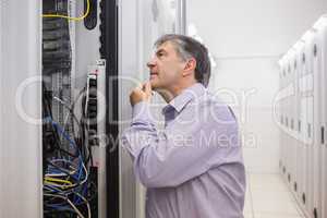 Man looking up thoughtfully into server locker
