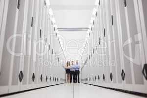 Three technicians standing at end of hallway