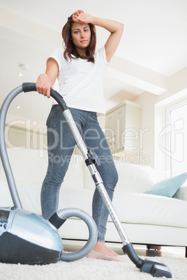 Tired woman doing the hoovering