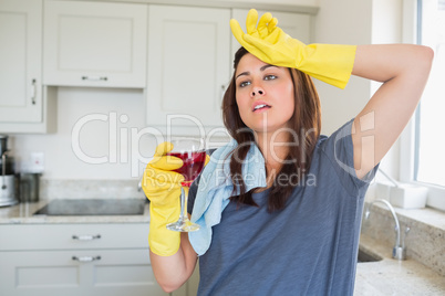 Woman standing holding a glass of wine