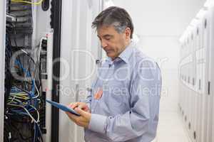Technician checking the server with tablet pc