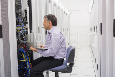 Technician controlling the server with a laptop
