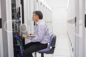 Technician controlling the server with a laptop