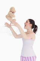 Woman throwing her teddy bear