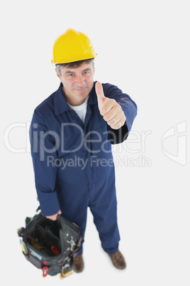 Mature man with tool bag showing thumbs up sign