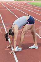 Woman stretching on the track