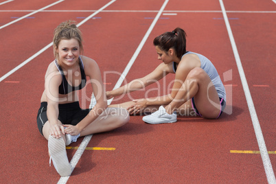 Women stretching on the track