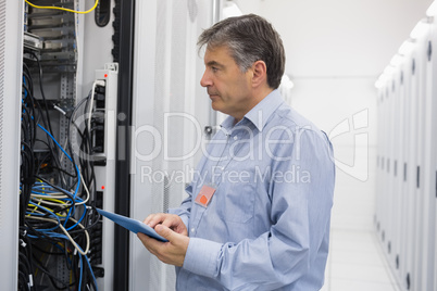 Man using tablet for maintenance on servers