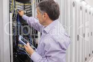 Man doing server maintenance with tablet