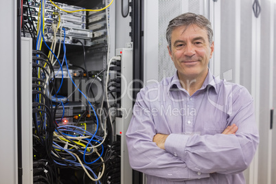 Smiling technician with arms crossed