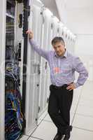 Man standing next to a server tower