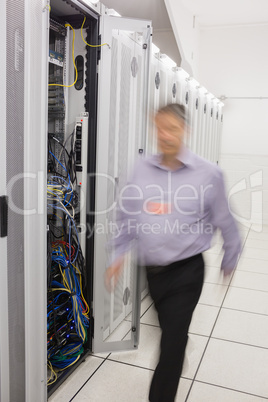 Technician walking next to a data store