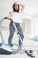 Tired woman with vacuum cleaner