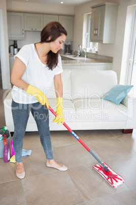 Woman mopping the living room floor