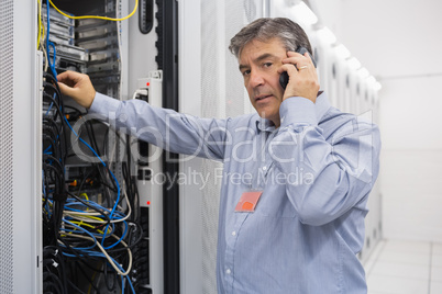 Technician working on server and phoning