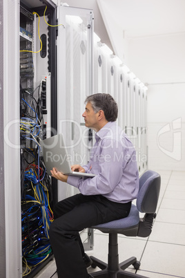 Technician checking the server with his laptop