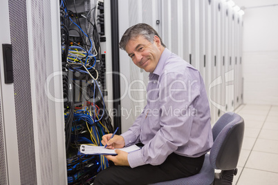 Happy technician repairing the server