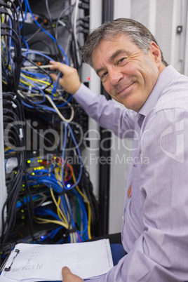 Smiling technician checking the server