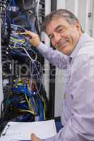 Smiling technician checking the server