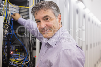 Technician changing cables in the server case