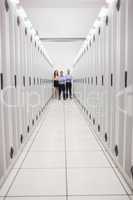 Technicians standing at end of server corridor