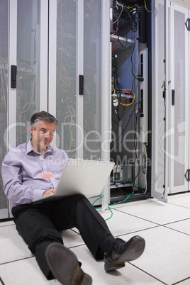 Technician repairing a server on the floor