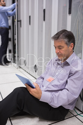 Technician checking his digital tablet