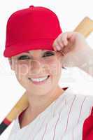 Woman holding a bat and her cap