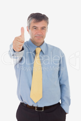 Portrait of businessman gesturing thumbs up