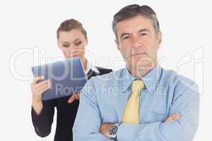 Confident businessman with coworker using tablet