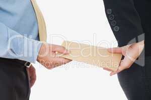 Businessman exchanging bribe with female coworker