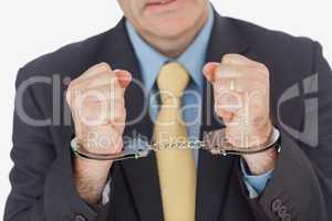 Close-up of businessman with handcuffed hands