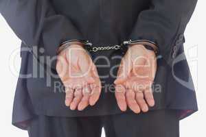 Close-up of handcuffed businessman
