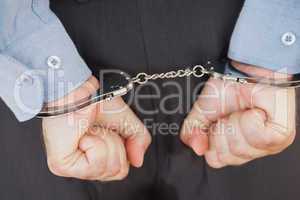 Businessman in handcuffs clenching fists