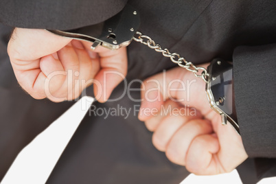 Businessman with handcuffs clencing fists