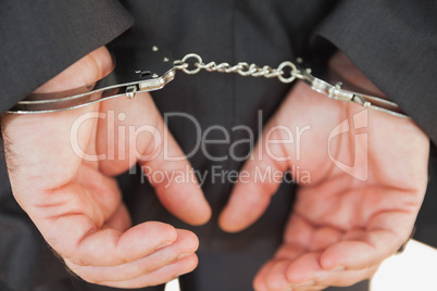 Handcuffed business criminal