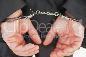 Handcuffed business criminal