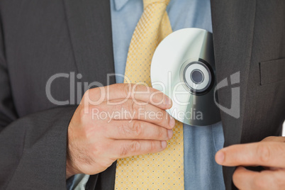 Businessman putting CD in pocket