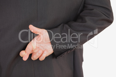 Businessman with fingers crossed