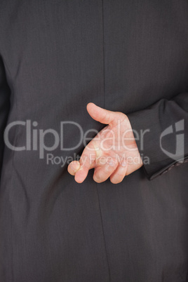 Businessman crossing fingers