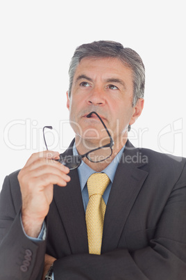 Thoughtful businessman with glasses looking up