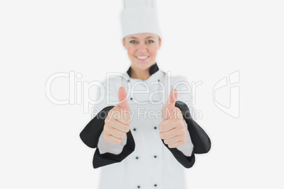 Happy female chef gesturing thumbs up