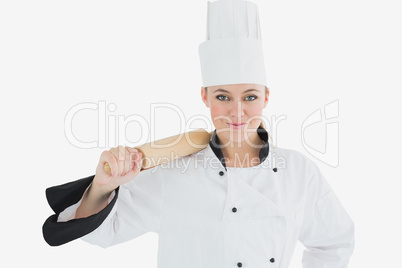 Female chef holding rolling pin