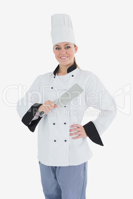 Female chef holding meat cleaver